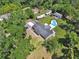 Stunning aerial view of a home featuring a pool, RV parking, outbuilding, and green landscape at 851 W Wisconsin Ave, Orange City, FL 32763