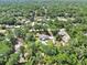Aerial view of a home with a pool and treed lot at 851 W Wisconsin Ave, Orange City, FL 32763