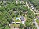 Wide aerial showcasing a home with a pool, RV parking, outbuilding, and surrounding neighborhood at 851 W Wisconsin Ave, Orange City, FL 32763