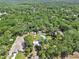 Aerial view of a home with a pool and treed lot at 851 W Wisconsin Ave, Orange City, FL 32763