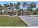 This back exterior features brick accents, hot tub, enclosed patio and spacious yard at 851 W Wisconsin Ave, Orange City, FL 32763