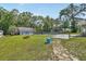 Large backyard featuring a pool, fire pit, storage shed, and concrete patio at 851 W Wisconsin Ave, Orange City, FL 32763