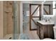 Beautiful bathroom featuring a glass enclosed shower and wood styled sliding door at 851 W Wisconsin Ave, Orange City, FL 32763
