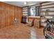 This is a bedroom with built-in shelves, wood paneling and laminate flooring at 851 W Wisconsin Ave, Orange City, FL 32763