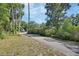 Paved driveway leading to a home with lush landscaping and a secluded feel at 851 W Wisconsin Ave, Orange City, FL 32763
