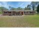 Well-maintained brick home with landscaped front yard and traditional shuttered windows at 851 W Wisconsin Ave, Orange City, FL 32763
