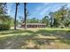 Charming single-story brick home with a covered porch and a spacious front yard at 851 W Wisconsin Ave, Orange City, FL 32763