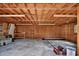 Unfinished garage interior with wood walls, exposed ceiling, and concrete floor at 851 W Wisconsin Ave, Orange City, FL 32763