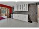 Stylish bar area with custom cabinets, a mini fridge, and a modern sliding barn door at 851 W Wisconsin Ave, Orange City, FL 32763