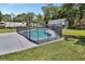 Backyard pool with safety fence, surrounded by lush landscaping at 851 W Wisconsin Ave, Orange City, FL 32763