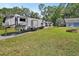 Exterior view of a RV parked on a grassy lot with an exterior building at 851 W Wisconsin Ave, Orange City, FL 32763