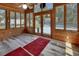 Inviting sunroom with wood-paneled walls, a ceiling fan, and views of the lush backyard at 851 W Wisconsin Ave, Orange City, FL 32763