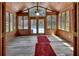 Cozy sunroom featuring wood paneled walls and plenty of natural light at 851 W Wisconsin Ave, Orange City, FL 32763