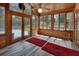 Light-filled sunroom with wood paneling, ceiling fan, and views of the outdoors and pool at 851 W Wisconsin Ave, Orange City, FL 32763