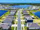 Stunning aerial view showcases a well-planned community with a large lake and lush landscaping at 918 Noble Run, New Smyrna Beach, FL 32168