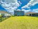 Spacious backyard featuring lush lawn, and black fencing for privacy and security at 918 Noble Run, New Smyrna Beach, FL 32168