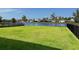 Scenic backyard view overlooking a serene lake with fountain and neighboring homes at 918 Noble Run, New Smyrna Beach, FL 32168