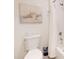 This simple bathroom features a tub with shower and a starfish art piece at 918 Noble Run, New Smyrna Beach, FL 32168