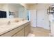 Bathroom featuring double sinks, white cabinetry, tile floors and a shower with dark shower curtain at 918 Noble Run, New Smyrna Beach, FL 32168