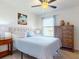 Bright bedroom features soft blue bedding and a large window for natural light at 918 Noble Run, New Smyrna Beach, FL 32168