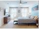 Bright bedroom features a striped bedspread and a large window for natural light at 918 Noble Run, New Smyrna Beach, FL 32168