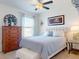 Comfortable bedroom featuring a queen size bed, ceiling fan, carpet, and natural light, creating a relaxing retreat at 918 Noble Run, New Smyrna Beach, FL 32168
