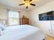 Bright bedroom features a ceiling fan and a large window for natural light at 918 Noble Run, New Smyrna Beach, FL 32168