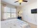 Bright bedroom features a ceiling fan and mounted television at 918 Noble Run, New Smyrna Beach, FL 32168