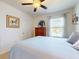 This cozy bedroom features neutral walls, ceiling fan, and a window for natural light at 918 Noble Run, New Smyrna Beach, FL 32168