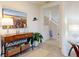Inviting entryway featuring a decorative table, neutral paint, tile floors, and staircase at 918 Noble Run, New Smyrna Beach, FL 32168