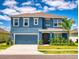 Charming two-story home with a blue facade, a well-kept lawn, and a welcoming two car garage at 918 Noble Run, New Smyrna Beach, FL 32168