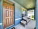 Charming front porch featuring a seating area, decorative door, and welcoming ambiance at 918 Noble Run, New Smyrna Beach, FL 32168