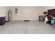 Spacious garage with gray epoxy flooring, overhead lighting, and lots of potential for storage at 918 Noble Run, New Smyrna Beach, FL 32168