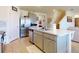 Modern kitchen features stainless steel appliances, gray cabinets, and a large island for food preparation and entertaining at 918 Noble Run, New Smyrna Beach, FL 32168