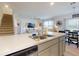 Modern kitchen featuring stainless appliances, a breakfast bar, and an adjacent staircase and living area at 918 Noble Run, New Smyrna Beach, FL 32168