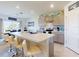 Open kitchen with gray cabinets, a white countertop island with seating, and modern appliances at 918 Noble Run, New Smyrna Beach, FL 32168