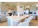 Bright kitchen with stainless appliances, gray cabinetry, a tile backsplash, and a spacious island at 918 Noble Run, New Smyrna Beach, FL 32168