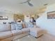 Open-concept living room featuring a comfortable sectional sofa, open kitchen access, and staircase to the upper level at 918 Noble Run, New Smyrna Beach, FL 32168
