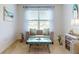 Bright sitting room featuring modern decor, a decorative seahorse themed side table, and natural light for ambiance at 918 Noble Run, New Smyrna Beach, FL 32168