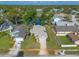 Aerial view of property showing proximity to pond, surrounding homes, and mature trees at 929 N Lakewood Ter, Port Orange, FL 32127