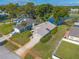 Aerial view of property showcasing landscaped yard, driveway, and proximity to the pond and other homes at 929 N Lakewood Ter, Port Orange, FL 32127