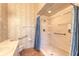 Bathroom featuring accessibility handrails, tiled floors, and a walk-in shower with a curtain at 929 N Lakewood Ter, Port Orange, FL 32127