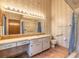 Bathroom with vanity and mirror, shower/tub with blue curtain, textured wallpaper and tile flooring at 929 N Lakewood Ter, Port Orange, FL 32127