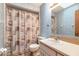 The bathroom features a shower-tub combo, blue patterned walls and a modern vanity at 929 N Lakewood Ter, Port Orange, FL 32127