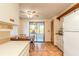 The kitchen and dining area features tile floors, an eat-in dining space, and sliding glass doors to the patio at 929 N Lakewood Ter, Port Orange, FL 32127