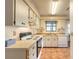 Functional kitchen with white cabinetry, tile flooring, and standard appliances at 929 N Lakewood Ter, Port Orange, FL 32127