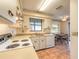 Traditional kitchen features white appliances, tile floors and an eat-in dining area with views of the backyard at 929 N Lakewood Ter, Port Orange, FL 32127