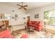Sunlit living room with neutral walls, a brick fireplace, and comfortable seating at 929 N Lakewood Ter, Port Orange, FL 32127
