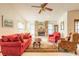 Cozy living room with a large window, brick fireplace, and a ceiling fan at 929 N Lakewood Ter, Port Orange, FL 32127