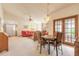 Open-concept living and dining area with a brick fireplace and glass doors at 929 N Lakewood Ter, Port Orange, FL 32127